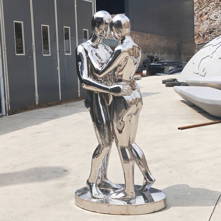 man and woman hug statue