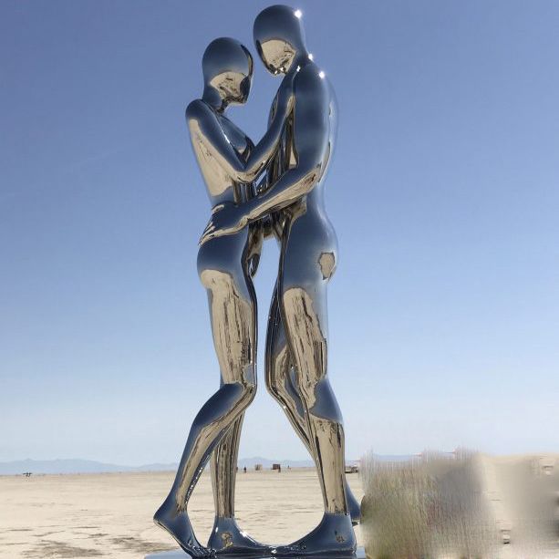 man and woman embrace sculpture